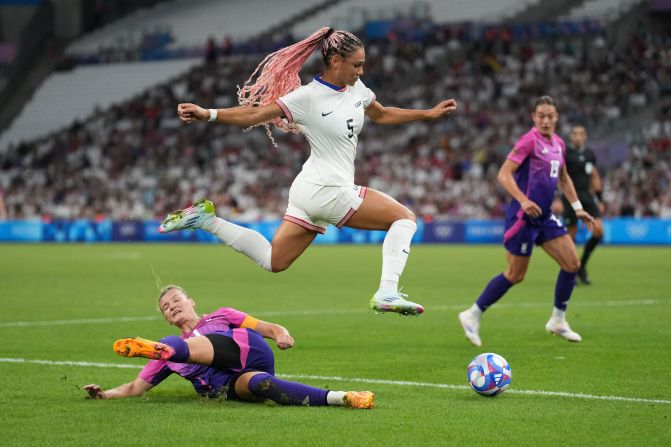 US forward Trinity Rodman jumps over Germany's Alexandra Popp during <a href="https://www.cnn.com/sport/live-news/paris-olympics-news-2024-07-28#h_120d2d453e327133d38d827ba7276d46">the Americans' 4-1 victory</a> on July 28.