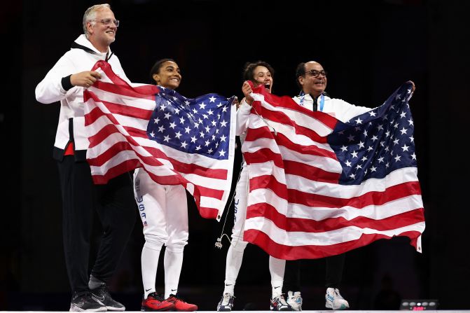 US fencers Lauren Scruggs, center left, and Lee Kiefer celebrate after facing off in the foil final on July 28. <a >Kiefer overwhelmed Scruggs 15-6</a> to win the event for the second straight Olympics.