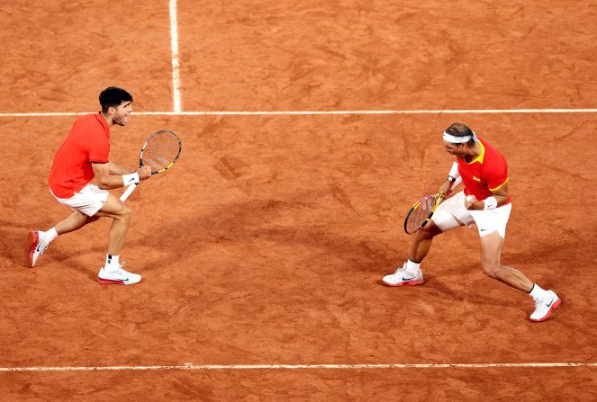 Spanish tennis players Carlos Alcaraz and Rafael Nadal celebrate during a doubles match on July 27. <a >The dream pairing</a> beat Argentina’s Máximo González and Andrés Molteni?7-6, 6-4.