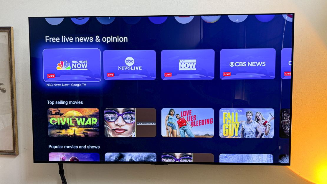 A tv plugged into an Onn 4K Pro shows two rows: Free live news & opinion and top selling movies