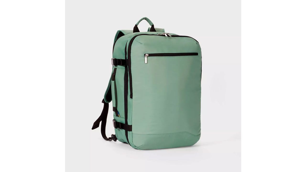 A photo of a light green Open Story 35L travel backpack