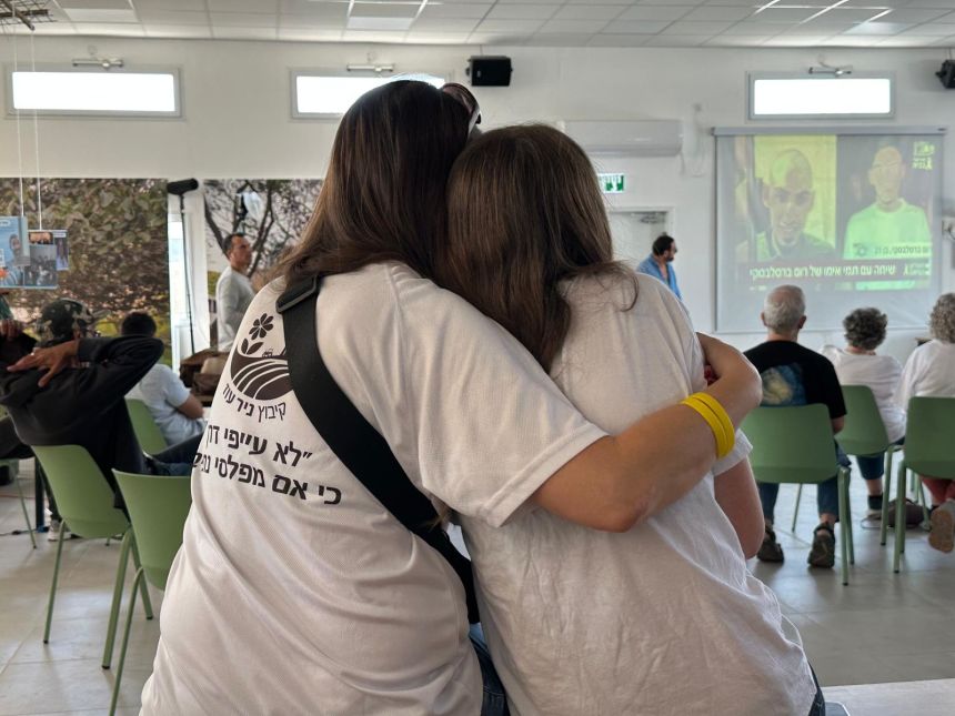 Two residents of Kibbutz Nir Oz embrace as they await the return of the remaining hostages in Gaza.