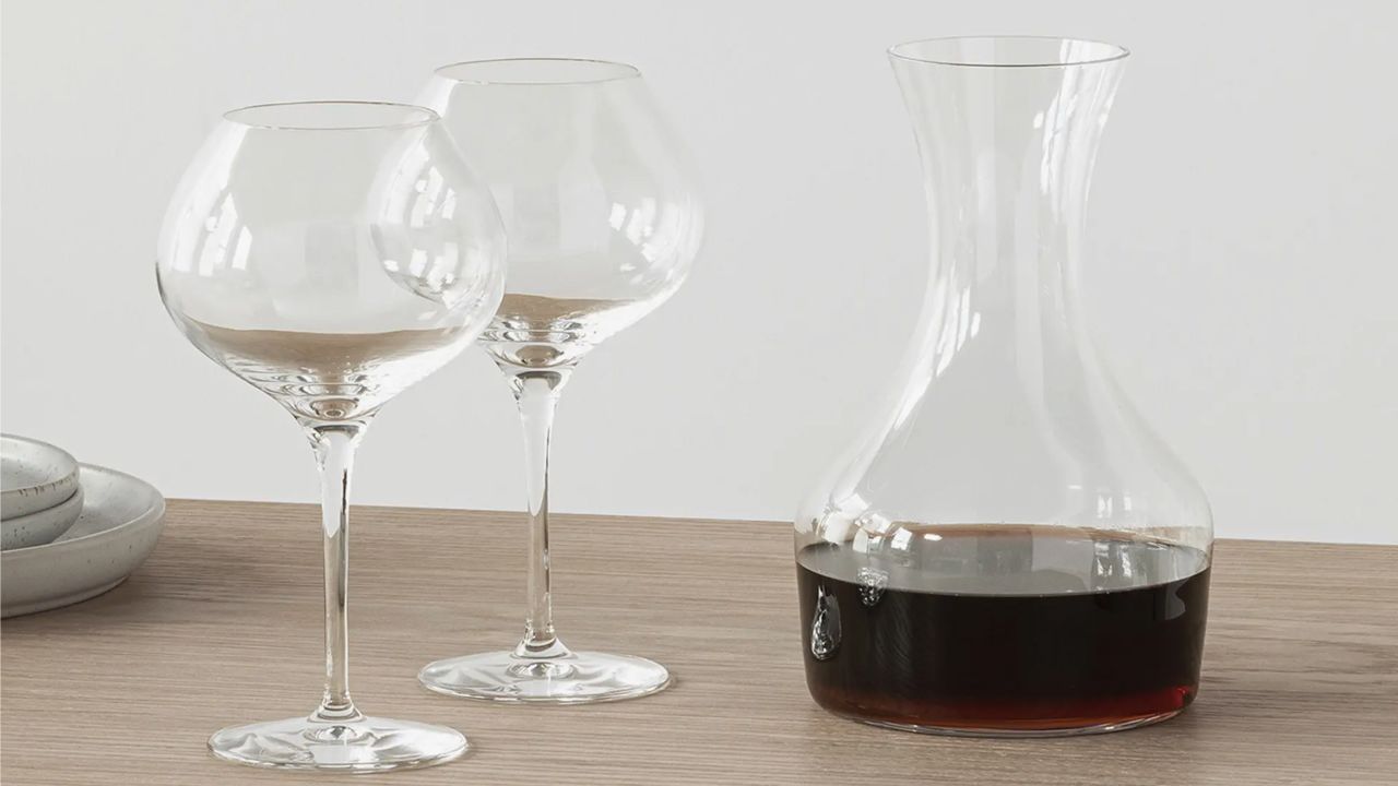 Two wine glasses and a carafe of red wine