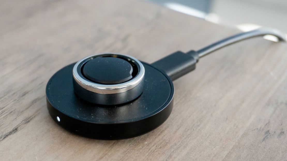 The Oura Ring on its charger.