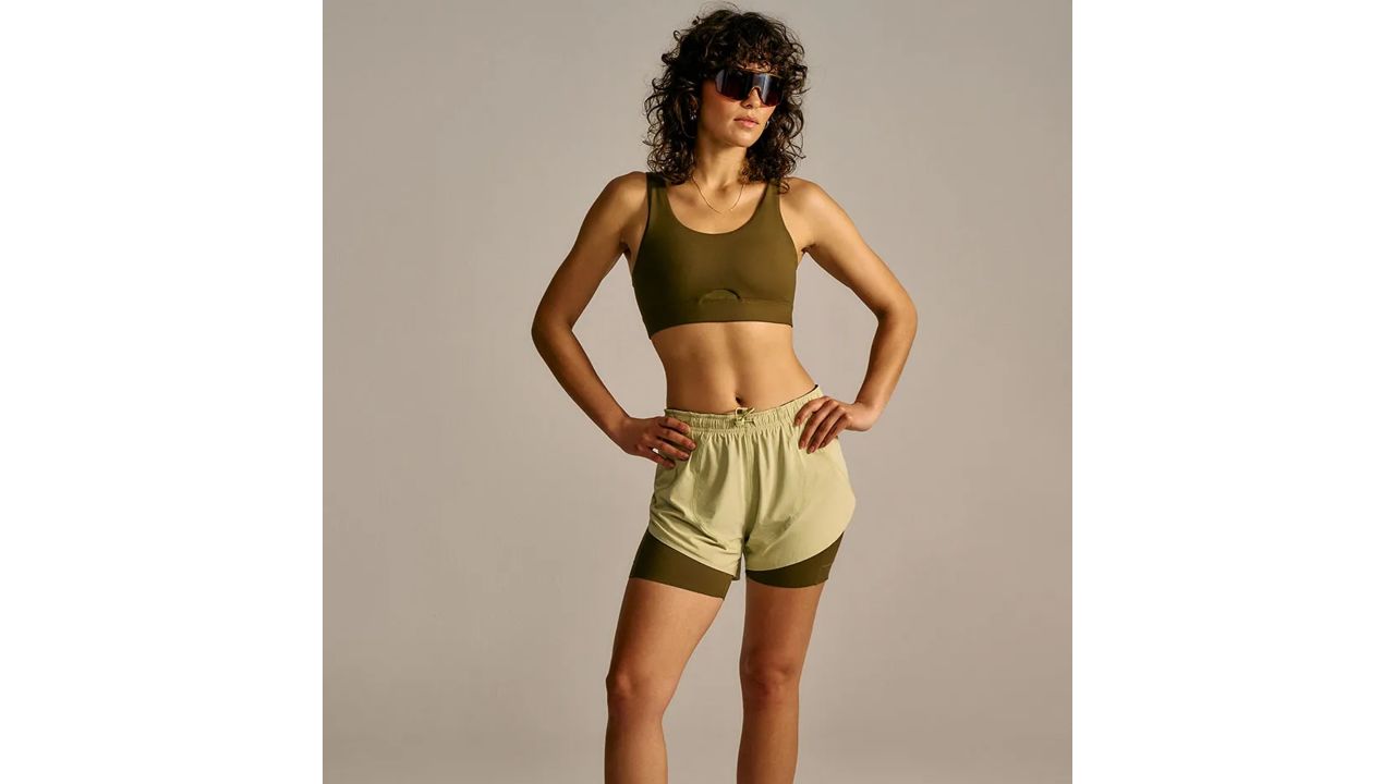 Woman wearing Outdoor voices coolform bra in dark olive