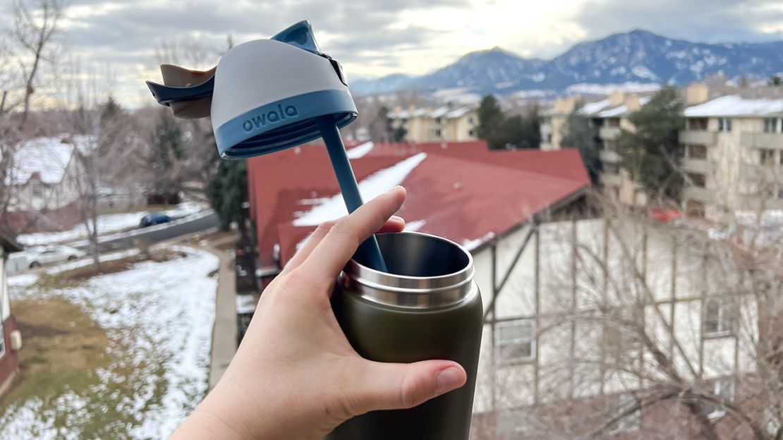 Green Owala water bottle with top off