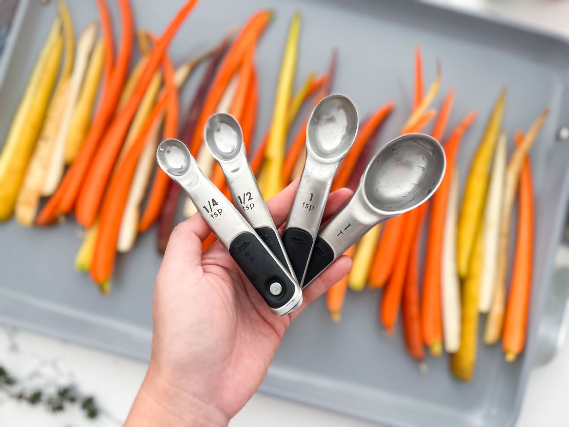 OXO measuring spoons with carrots in the background