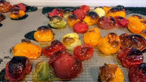Roast yellow and red cherry tomatoes on a baking sheet