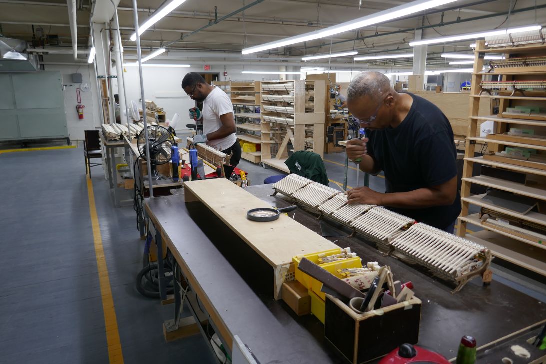 Bernard Craddock (right) at work at the Steinway & Sons factory in Queens, New York, on September 4, 2025.