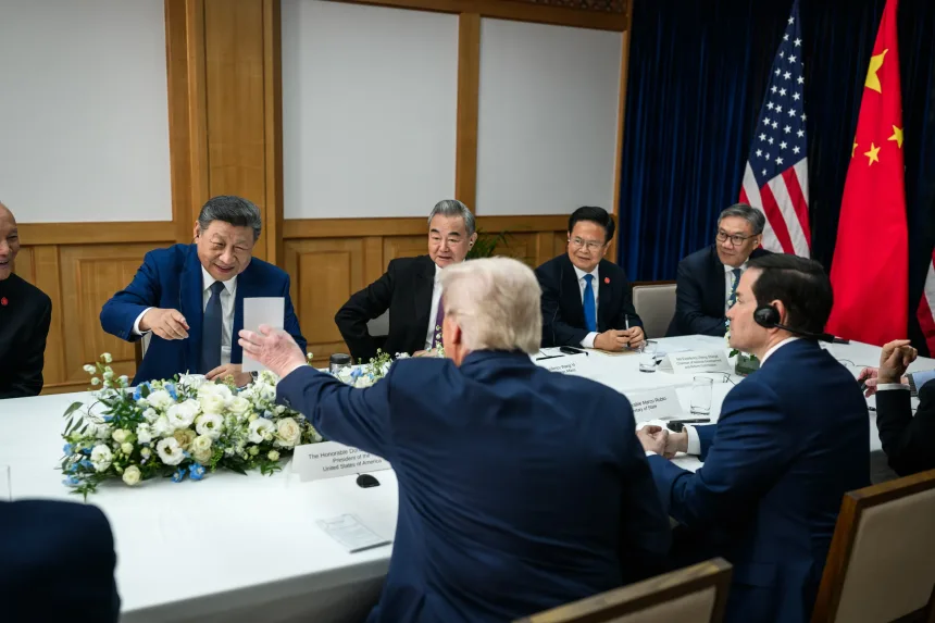 Trump shows Xi a piece of paper during the meeting.