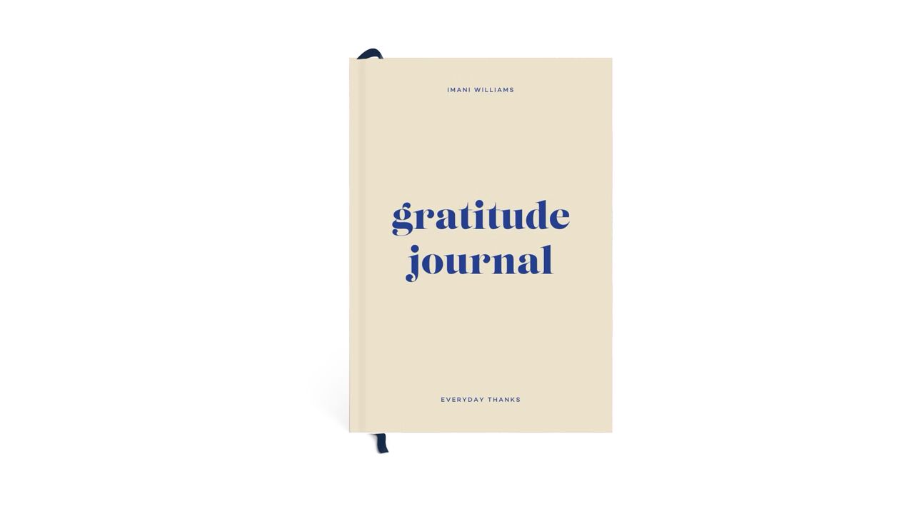 A photo of a yellow Papier Joy Gratitude Journal