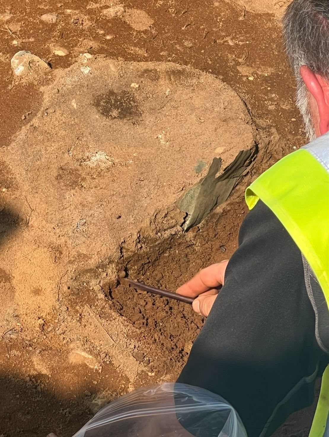 A researcher excavates part of the Bromeswell bucket from the trench at Sutton Hoo.