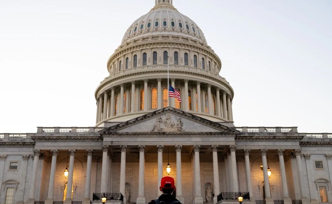 A Trump supporter takes photos outside the US Capitol in Washington on Saturday.