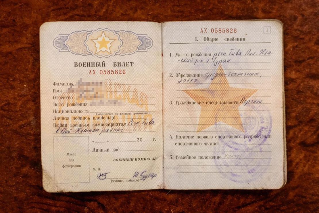 A video and still photograph show a Russian military ID which Ukraine claims was carried by a North Korean soldier taken captive by Ukrainian forces. CNN has blurred the name and date of birth on the ID.