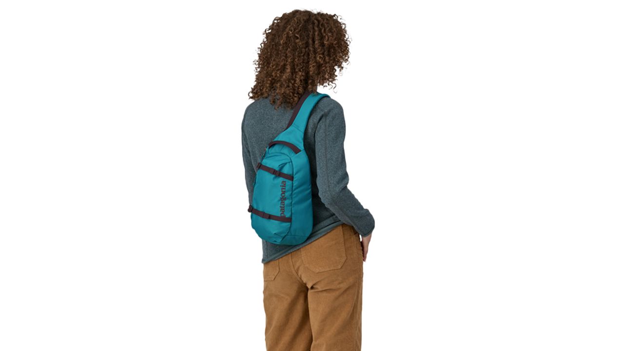 Woman wearing blue patagonia atom sling bag