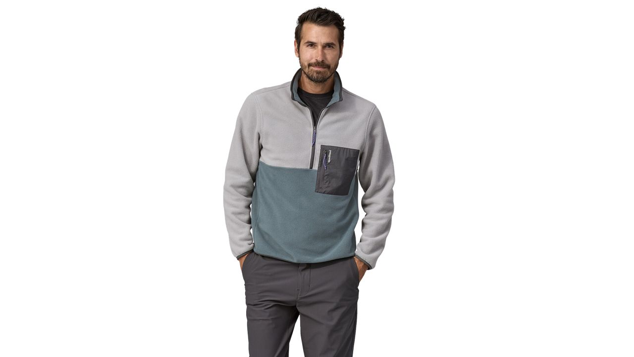 Man wearing Patagonia microdini fleece pullover in salt grey