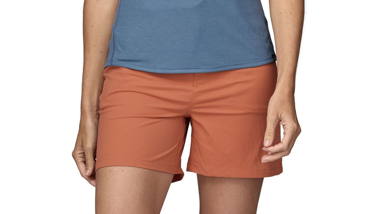 Woman wearing patagonia quandary shorts in sienna clay color