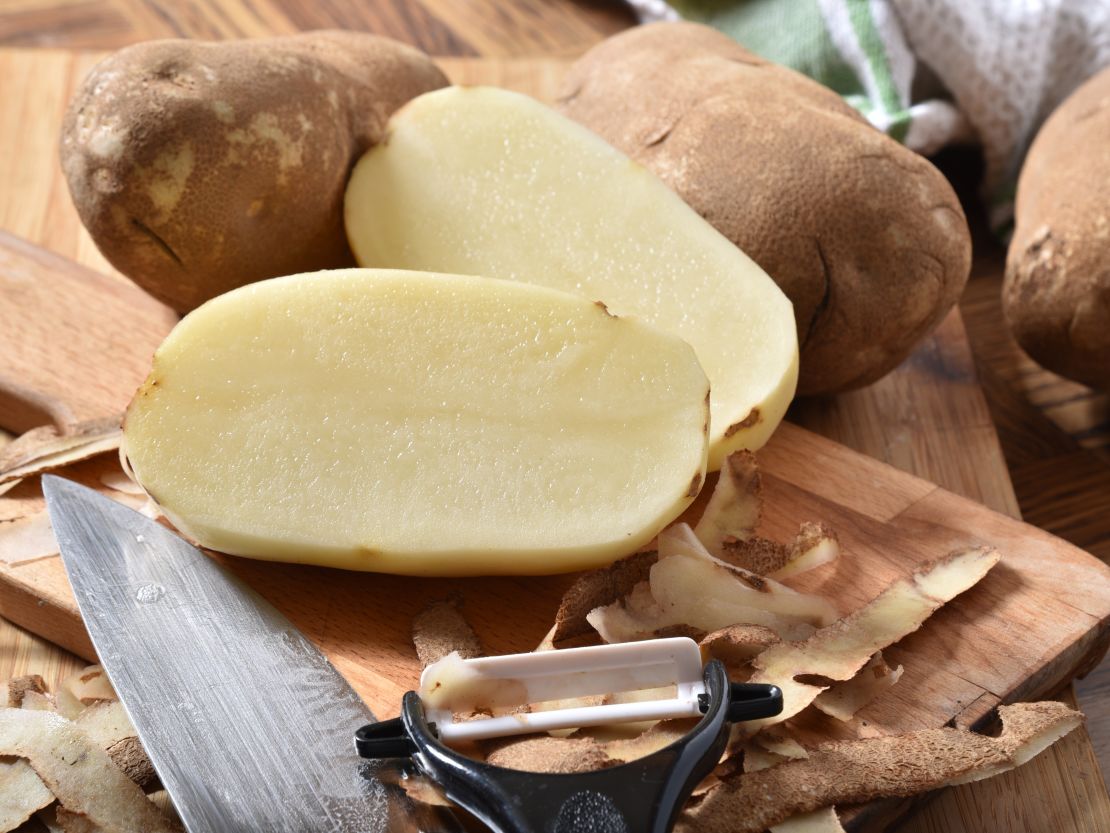 peeling-russet-potatoes-on-cutting-board.jpg