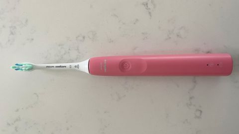 The Philips Sonicare 4100 electric toothbrush on a marble countertop