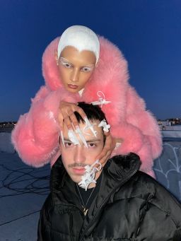 Nail artist Juan Alvear, posing with a manicured model.