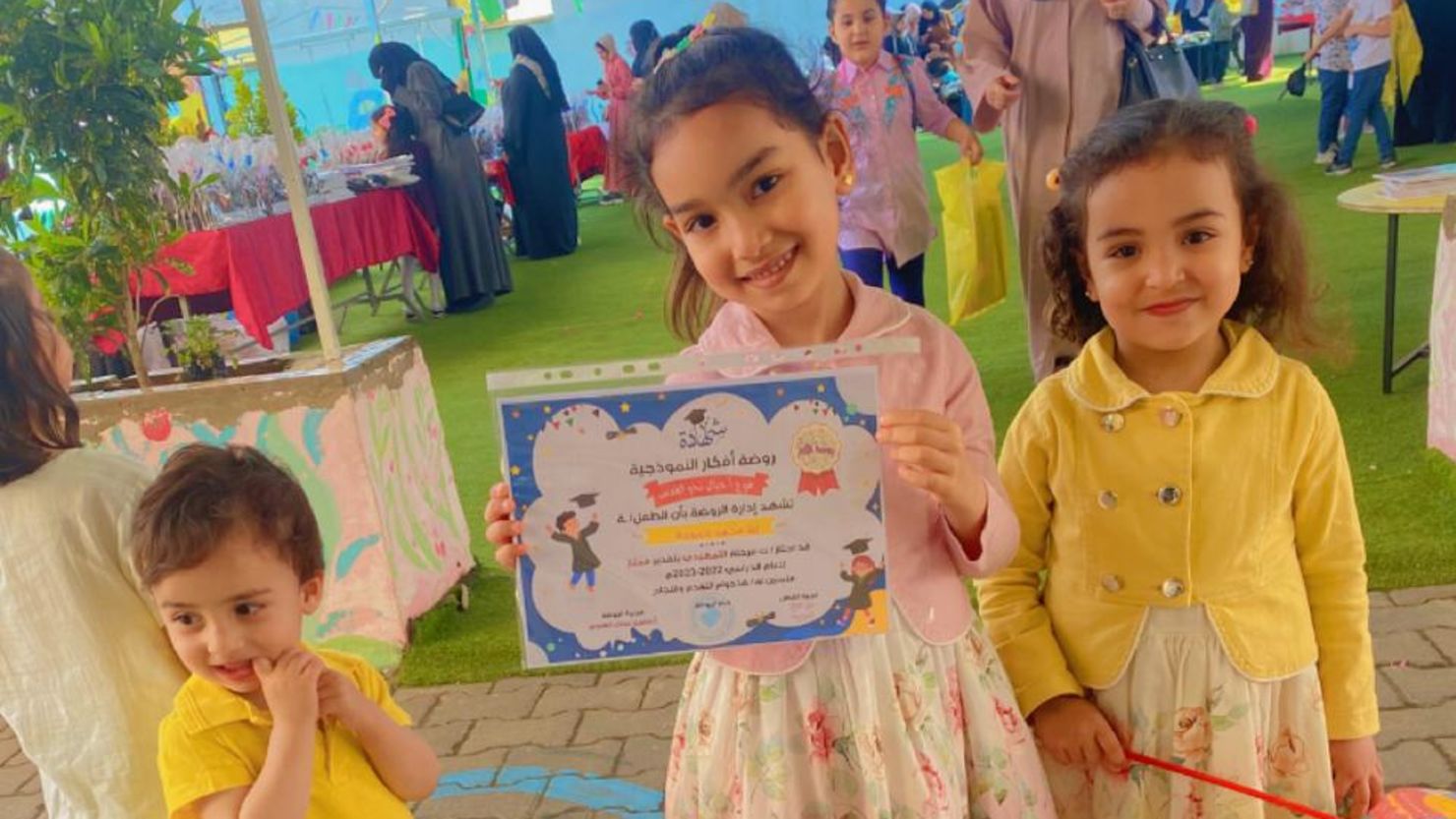 The Hamouda siblings, Kareem, aged 2 (left), Ella, aged 6 (center) and Sila aged 4, at a pre-school graduation celebration on June 15, 2023.