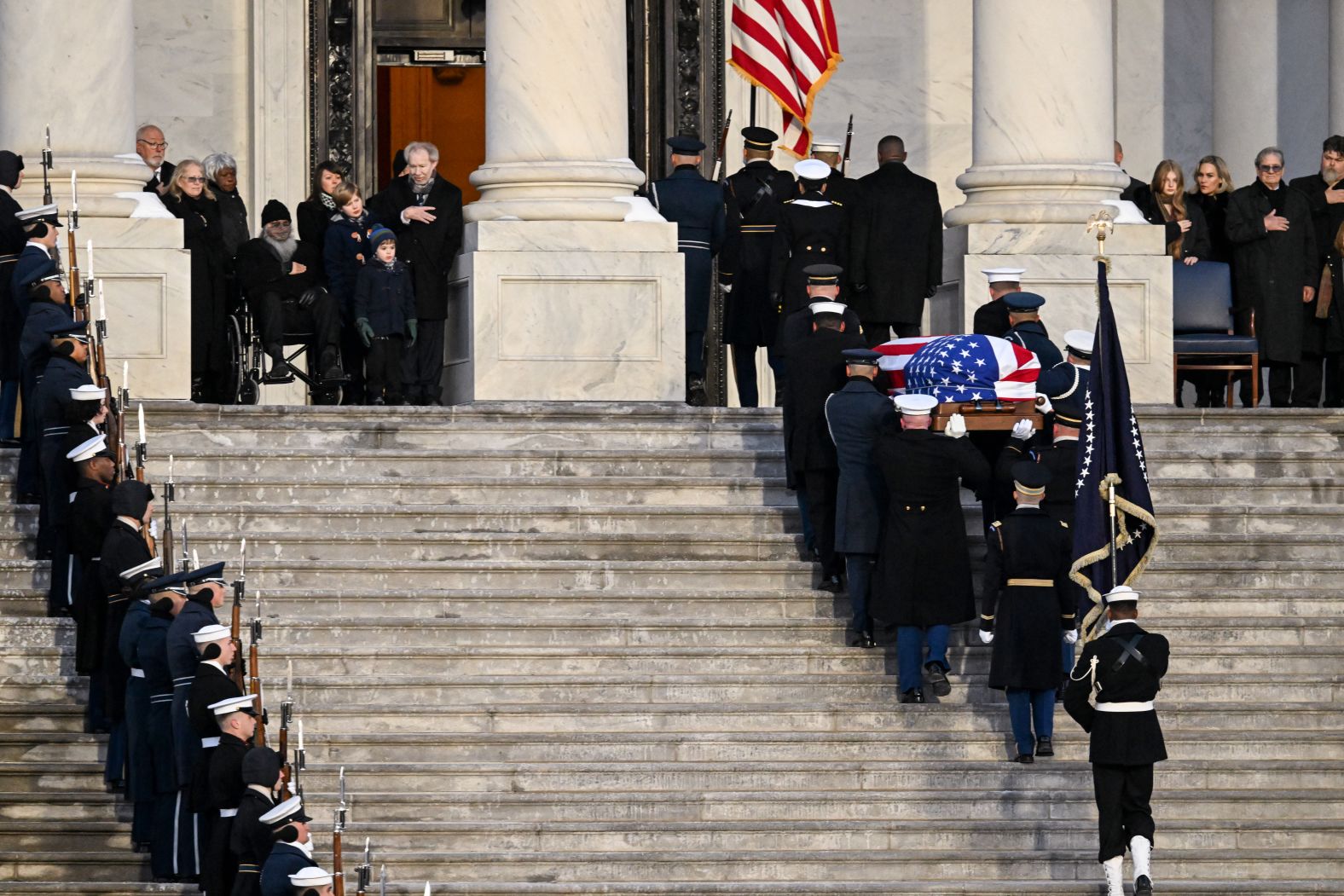 Carter's casket is carried up the Capitol steps.