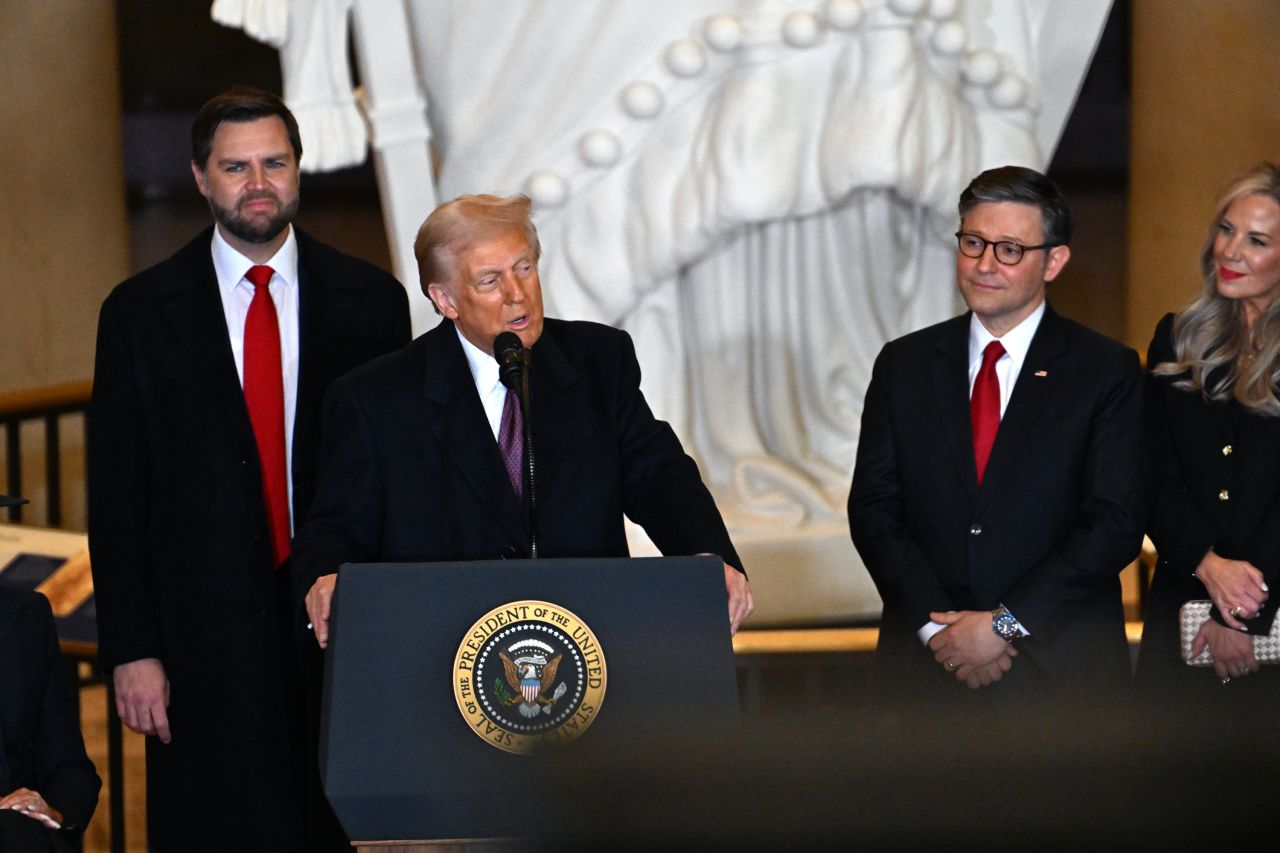 House Speaker Mike Johnson, right, looks on President Donald Trump speaks in Washington, DC on Monday.