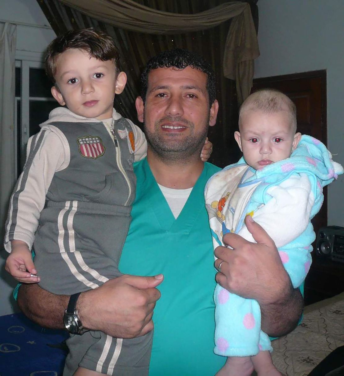 Al-Bursh is pictured with his two children. Colleagues told CNN the doctor "loved life."