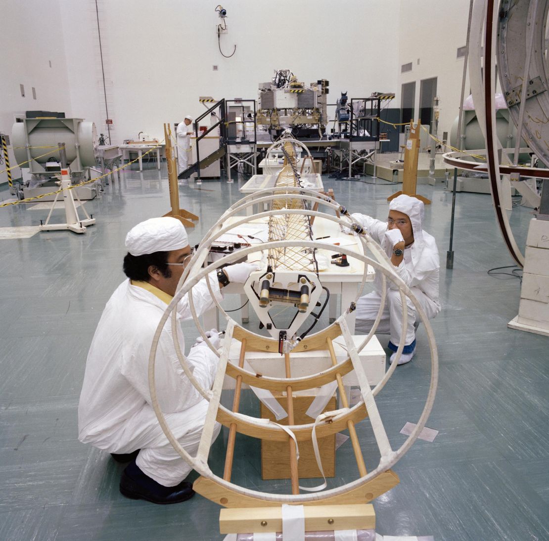 An archival photo shows engineers working with the deployed magnetometer boom of one of NASA’s Voyager spacecraft in Florida on June 17, 1977.