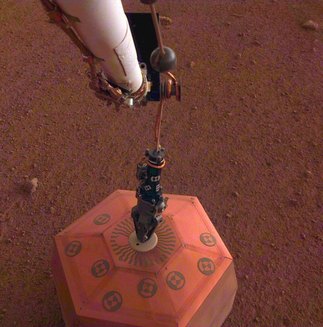 On December 19, 2018, InSight's white robot arm and black arm-like Grapple used the first seismic measurement on another planet.