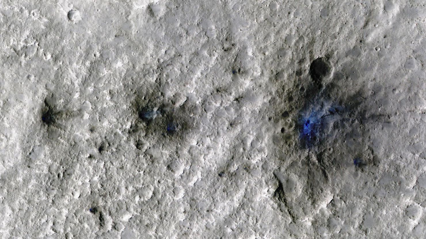 A meteoroid impact on Mars formed Martian craters, seen in blue, on September 5, 2021. NASA's InSight mission detected the impacts, and the Mars Reconnaissance Orbiter imaged the craters.