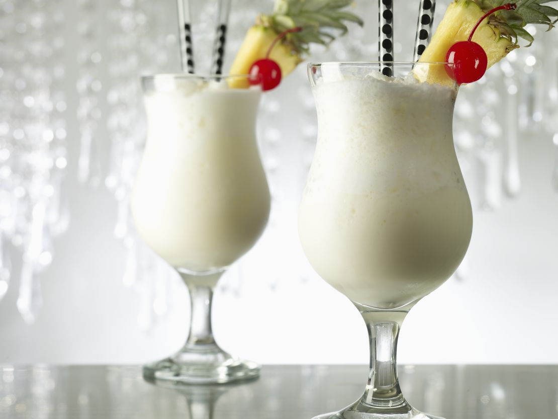 pina-colada-cocktails-in-glasses-with-fruit-garnish-and-white-background.jpg