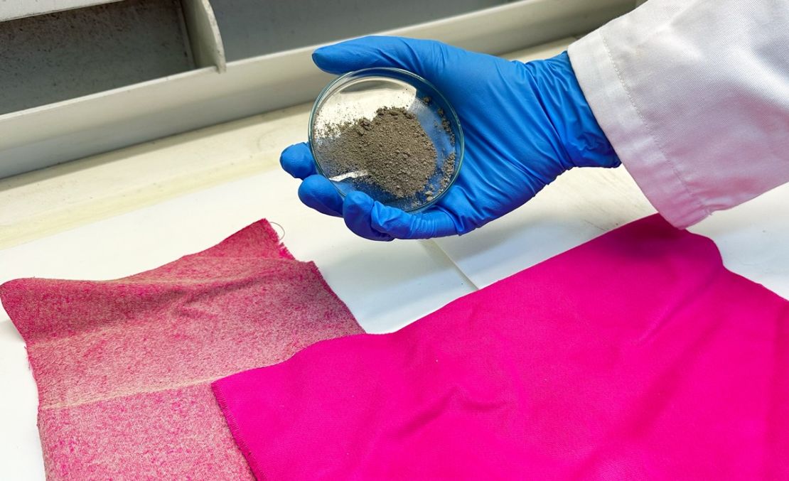 A sample of the treated fabric (L) used in RMIT University's study, next to a sample of untreated fabric (R), with a researcher holding dish of nanodiamonds.