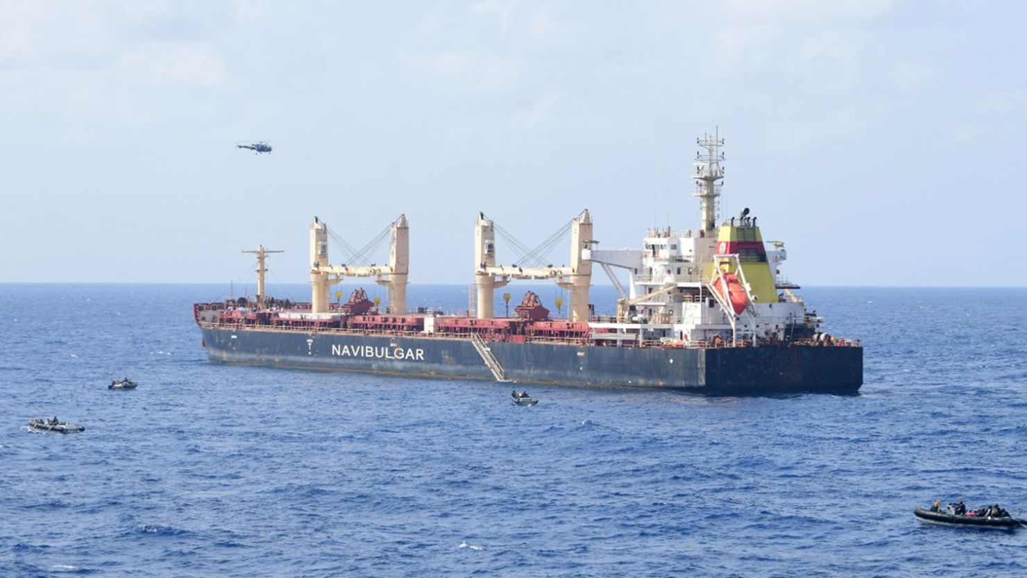 Boats maneuver around the pirated commercial ship MV Ruen during an Indian military operation on Saturday.