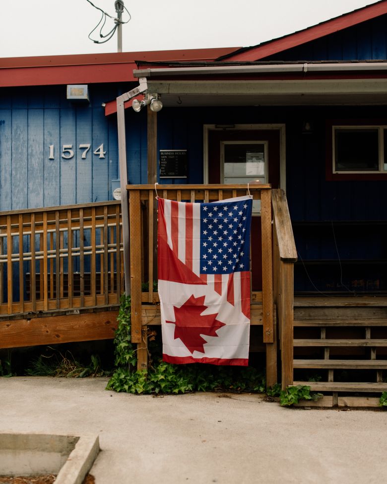 A split US-Canada flag hangs from the porch of a business in Point Roberts. The town is cut off from the continental US and relies on Canada for almost all aspects of daily life.