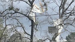 Katt Lomison told CNN that a tornado damaged her backyard shed and garage door and caused extensive destruction in her neighborhood in Porter, Texas, on Saturday.