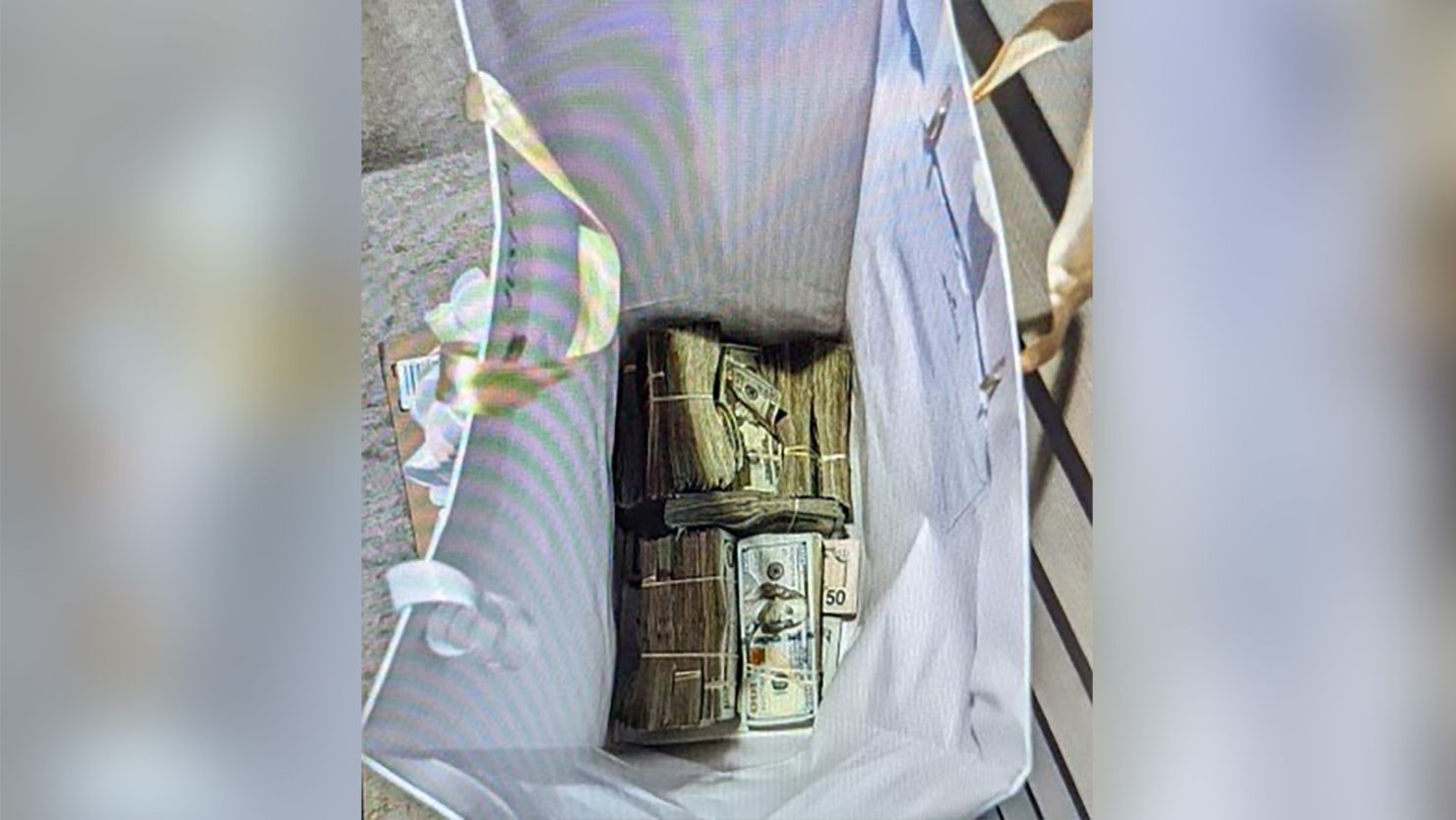Prosecutors allege that a gift bag full of money was left at a juror's home.