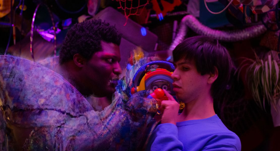 Aspiring toymaker Alejandro's struggles to earn cash via odd jobs on Craigslist are depicted in this scene, where the classified ad website is personified by actor Larry Owens (left). Actor Julio Torres (right), who wrote and directed the film in addition to playing Alejandro, says he drew inspiration from his own life.
