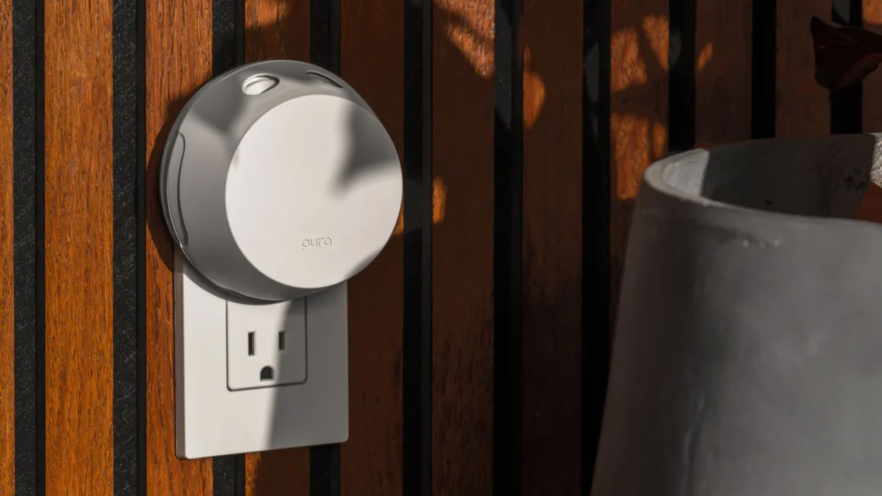 A fragrance diffuser plugged into a wooden wall.