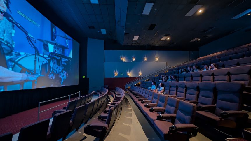 An audience watches previews ahead of a 