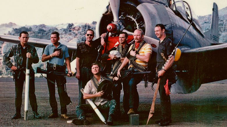 Raven forward air controllers jokingly pose for a group photo in front of a T-28 at Long Tieng, Laos, 1970.