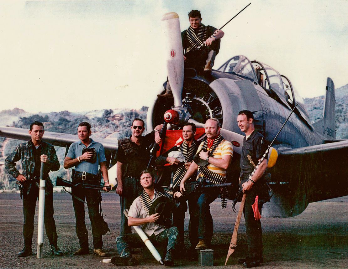Raven forward air controllers pose for a group photo in front of a T-28 in Long Tieng in 1970.