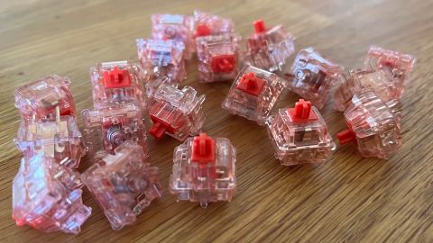 A group of mechanical keyboard switches, of the linear "red" type.