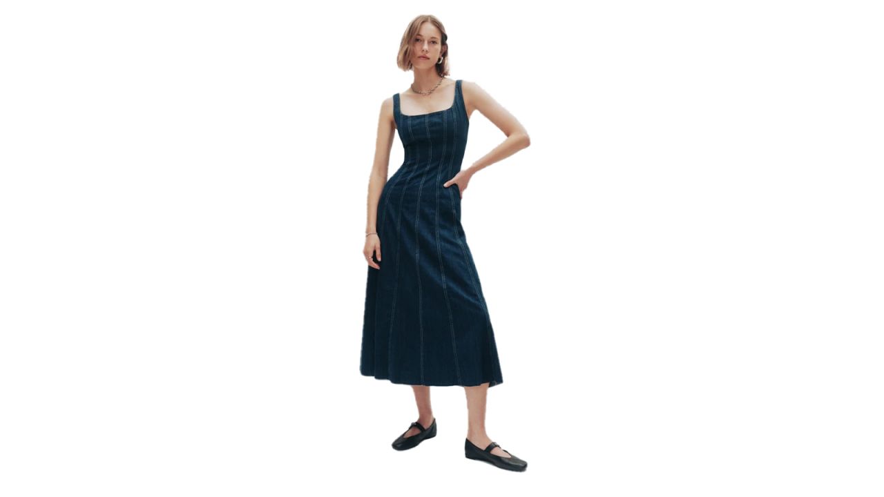 A woman in the Reformation Amory Denim Midi Dress.