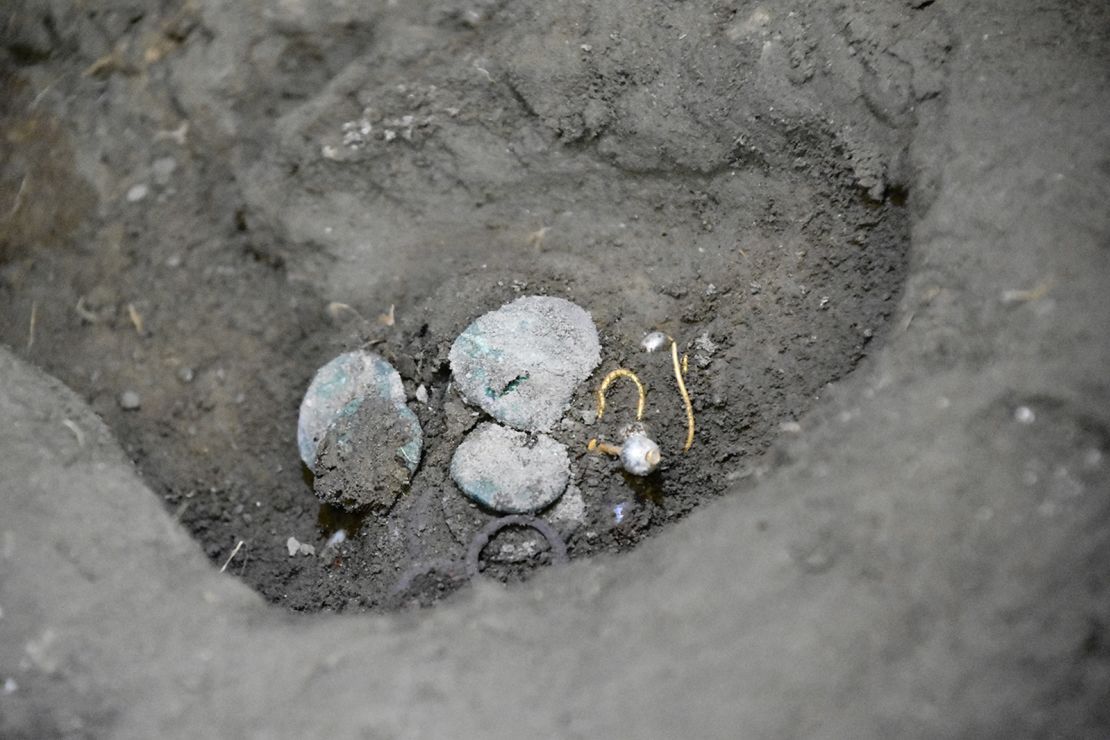 The woman was found holding coins and jewelry.