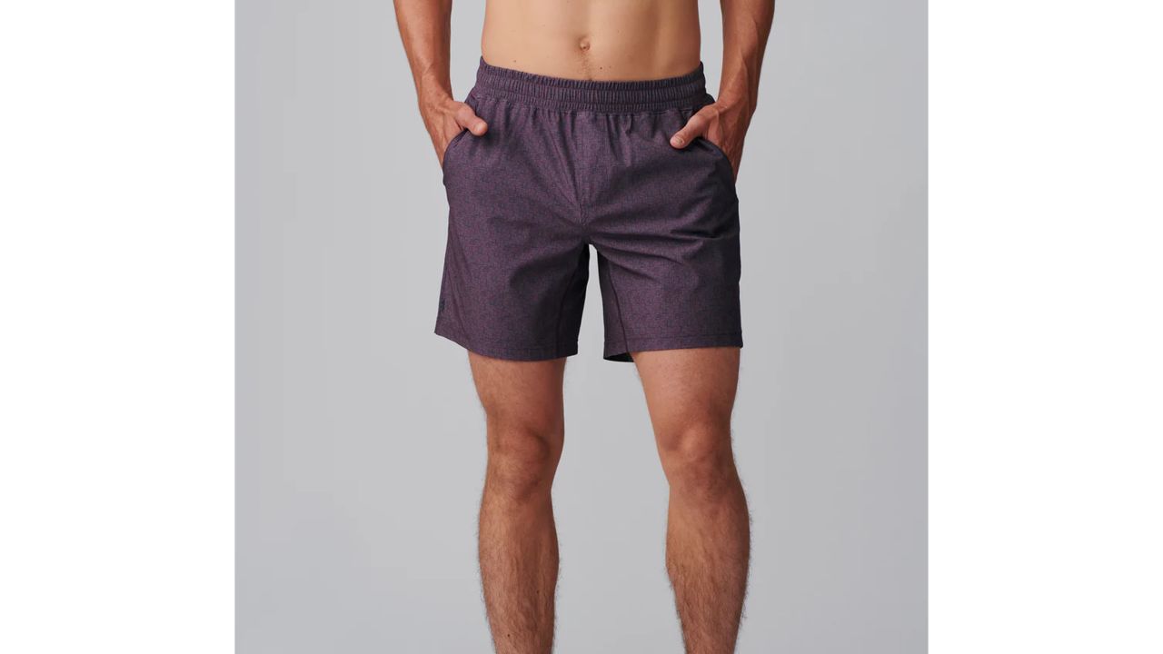 Man wearing rhone mako shorts in maroon