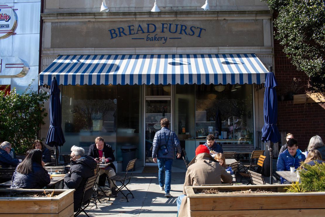 People eat outside at Bread Furst in Washington, DC, on Saturday.