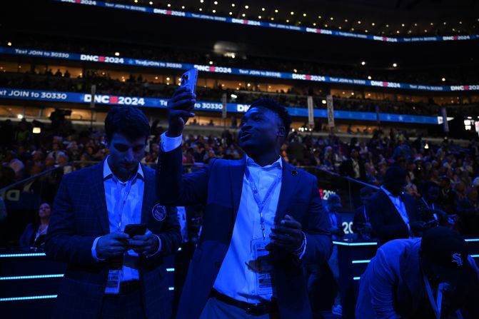 Content creator Joshua Martin records a video from the convention floor on Monday.