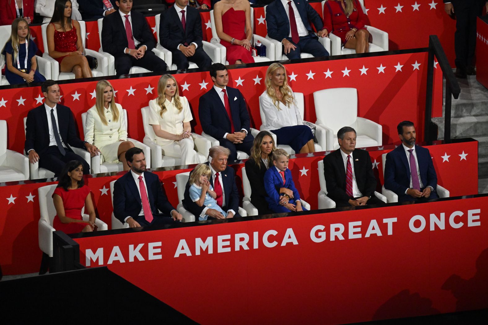 Trump listens to convention speakers with members of his family and special guests.