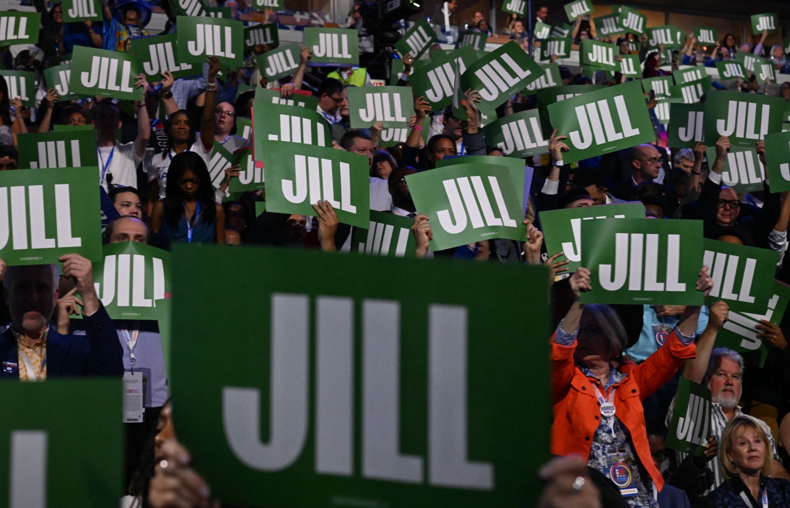 Delegates hold up signs for Jill Biden as she gives a speech at the convention on Monday.